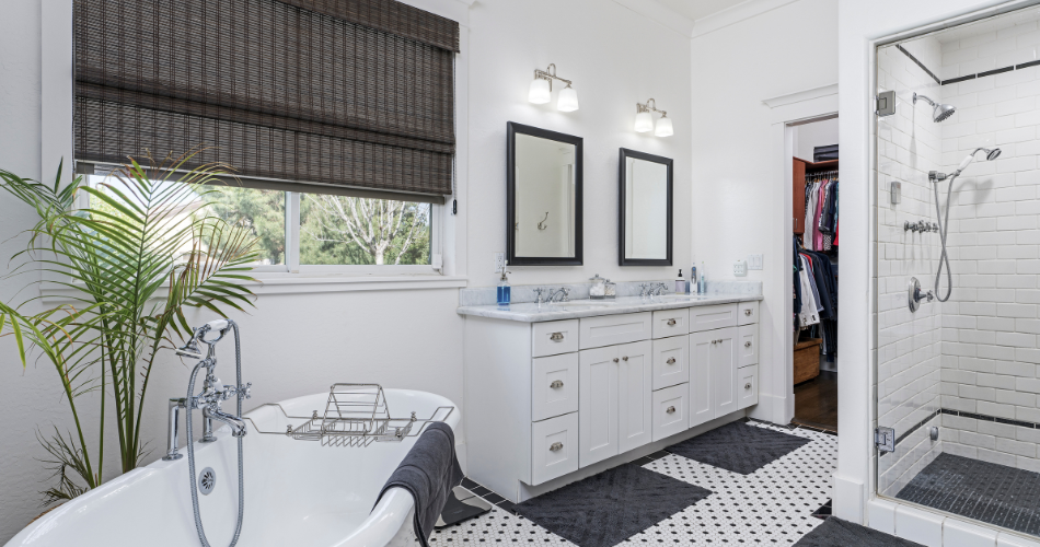 Compact yet elegant bathroom design showcasing smart storage solutions, a walk-in shower with clear glass doors, and a single vanity with bright, energy-efficient lighting.